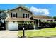 Charming home with a well-maintained lawn, an attached garage, and a cozy front porch at 6325 Stablewood Way, Lithonia, GA 30058