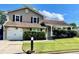 Charming home with a well-maintained lawn, an attached garage, and a cozy front porch at 6325 Stablewood Way, Lithonia, GA 30058