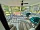 Bright sunroom with floor to ceiling windows, bar seating, and comfortable egg chairs at 6325 Stablewood Way, Lithonia, GA 30058