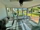Bright sunroom with floor to ceiling windows, bar seating, and comfortable sofa at 6325 Stablewood Way, Lithonia, GA 30058