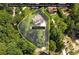 Aerial view of home with property lines displayed, surrounded by lush greenery and trees at 7540 Shadburn Ferry Rd, Cumming, GA 30041