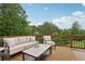 Back deck featuring outdoor seating, rug, and coffee table at 7540 Shadburn Ferry Rd, Cumming, GA 30041