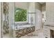 Bright bathroom featuring a Jason Microsilk Tub and towel warmer at 7540 Shadburn Ferry Rd, Cumming, GA 30041