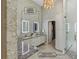 Bathroom showcasing lighted medicine cabinets and a jetted shower with barrier-free entry at 7540 Shadburn Ferry Rd, Cumming, GA 30041