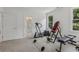 Bright exercise room with natural light, neutral carpet, and a variety of workout equipment at 7540 Shadburn Ferry Rd, Cumming, GA 30041
