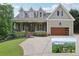 Charming two-story home with a landscaped front yard and a view of Lake Lanier at 7540 Shadburn Ferry Rd, Cumming, GA 30041