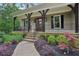 Inviting front porch with dark wood accents and manicured landscaping at 7540 Shadburn Ferry Rd, Cumming, GA 30041