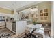 Bright, modern kitchen with white cabinets, stainless steel appliances, and a stylish dining area with bench seating at 7540 Shadburn Ferry Rd, Cumming, GA 30041