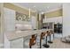 Modern kitchen featuring sleek white cabinets, marble countertops, and a breakfast bar at 7540 Shadburn Ferry Rd, Cumming, GA 30041