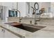 Gourmet kitchen sink featuring dual faucets and a marble countertop, perfect for food preparation and cleanup at 7540 Shadburn Ferry Rd, Cumming, GA 30041