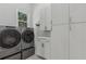 Well-equipped laundry room with modern washer and dryer, ample cabinet space, and a convenient layout at 7540 Shadburn Ferry Rd, Cumming, GA 30041