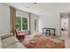 Inviting living room with hardwood floors, a floral rug, and natural light from a large window at 7540 Shadburn Ferry Rd, Cumming, GA 30041