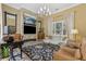 Cozy living room with a stone fireplace, large windows, and comfortable seating, perfect for relaxation at 7540 Shadburn Ferry Rd, Cumming, GA 30041