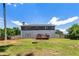 The backyard features a wooden deck, fire pit, partial privacy fence, and a two-story home with gray siding at 209 Courtland Oaks Sw Dr, Marietta, GA 30060