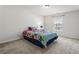 Cozy bedroom with a floral comforter, window, and neutral carpeting at 209 Courtland Oaks Sw Dr, Marietta, GA 30060