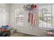 Well-lit closet with shelving, clothing racks, two windows, and household storage on display at 209 Courtland Oaks Sw Dr, Marietta, GA 30060