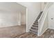 Bright entryway featuring wood-look floors, staircase, and an open view to carpeted living space at 209 Courtland Oaks Sw Dr, Marietta, GA 30060