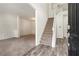 Bright entryway featuring wood-look floors, staircase, and an open view to carpeted living space at 209 Courtland Oaks Sw Dr, Marietta, GA 30060