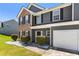 Two-story home with brick and gray facade, neat front yard and a two-car garage at 209 Courtland Oaks Sw Dr, Marietta, GA 30060