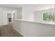 Upstairs hallway with a view into a bedroom and a bright window at 209 Courtland Oaks Sw Dr, Marietta, GA 30060
