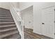 Hallway and stairway with carpeted steps and hardwood floors at 209 Courtland Oaks Sw Dr, Marietta, GA 30060