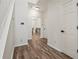 Hallway features wood-look flooring, white walls, a staircase and access to a room with carpet at 209 Courtland Oaks Sw Dr, Marietta, GA 30060