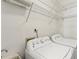Bright laundry room with front load machines and wire rack shelving at 209 Courtland Oaks Sw Dr, Marietta, GA 30060