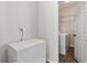 Bright laundry room with front load machines and chest freezer at 209 Courtland Oaks Sw Dr, Marietta, GA 30060