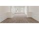 Spacious, carpeted living room with elegant wainscoting, pillars and natural light streaming through the windows at 209 Courtland Oaks Sw Dr, Marietta, GA 30060
