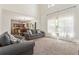Open-concept living room leading to a kitchen area, featuring high ceilings, plush carpeting, and great natural light at 209 Courtland Oaks Sw Dr, Marietta, GA 30060