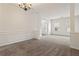 Spacious living room featuring neutral carpet, decorative wall trim, and a modern chandelier at 209 Courtland Oaks Sw Dr, Marietta, GA 30060