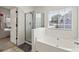 Bathroom featuring soaking tub and glass shower at 209 Courtland Oaks Sw Dr, Marietta, GA 30060