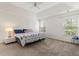 Spacious main bedroom with large windows and carpet floors at 209 Courtland Oaks Sw Dr, Marietta, GA 30060