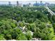 Stunning aerial view of a luxury home nestled among lush greenery, offering privacy and city views at 4015 Wieuca Ne Rd, Atlanta, GA 30342
