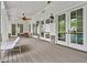 Charming back porch featuring wood floors, ceiling fans and french doors overlooking the pool area at 4015 Wieuca Ne Rd, Atlanta, GA 30342