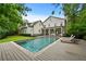 Expansive backyard featuring a sparkling pool, lush lawn, and lounge chairs, perfect for outdoor living at 4015 Wieuca Ne Rd, Atlanta, GA 30342