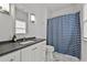 Stylish bathroom with patterned shower curtain, marble countertop, and modern vanity at 4015 Wieuca Ne Rd, Atlanta, GA 30342