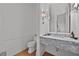 Elegant powder room with a marble vanity, modern fixtures, and wainscoting at 4015 Wieuca Ne Rd, Atlanta, GA 30342