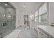 Bright bathroom with marble floors, frameless shower, and windows at 4015 Wieuca Ne Rd, Atlanta, GA 30342