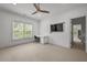 Bright bedroom with a built-in desk area, a ceiling fan, and neutral carpeting at 4015 Wieuca Ne Rd, Atlanta, GA 30342