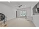 Bright bedroom with a built-in desk area, a ceiling fan, and neutral carpeting at 4015 Wieuca Ne Rd, Atlanta, GA 30342