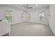 Spacious bedroom with neutral carpet, ceiling fan, and natural light from multiple windows at 4015 Wieuca Ne Rd, Atlanta, GA 30342