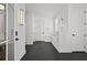 Entryway featuring black slate flooring, white trim, and modern light fixtures at 4015 Wieuca Ne Rd, Atlanta, GA 30342