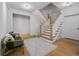 Bright foyer featuring hardwood floors, stairway, and white trim at 4015 Wieuca Ne Rd, Atlanta, GA 30342