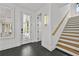 Bright foyer with black tile flooring, white trim, and staircase with light wood treads at 4015 Wieuca Ne Rd, Atlanta, GA 30342