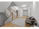 Bright hallway with wooden floors, stairs, and a cozy seating area at 4015 Wieuca Ne Rd, Atlanta, GA 30342