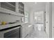 Bright hallway with marble floors, beverage cooler, and seating area at 4015 Wieuca Ne Rd, Atlanta, GA 30342