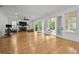 Large open living room features fireplace, hardwood floors, and access to outdoor space at 4015 Wieuca Ne Rd, Atlanta, GA 30342