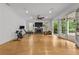 Spacious living room featuring fireplace, hardwood floors, and access to outdoor patio at 4015 Wieuca Ne Rd, Atlanta, GA 30342