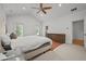 Airy bedroom with plush carpet, a king-size bed, and a modern ceiling fan at 4015 Wieuca Ne Rd, Atlanta, GA 30342